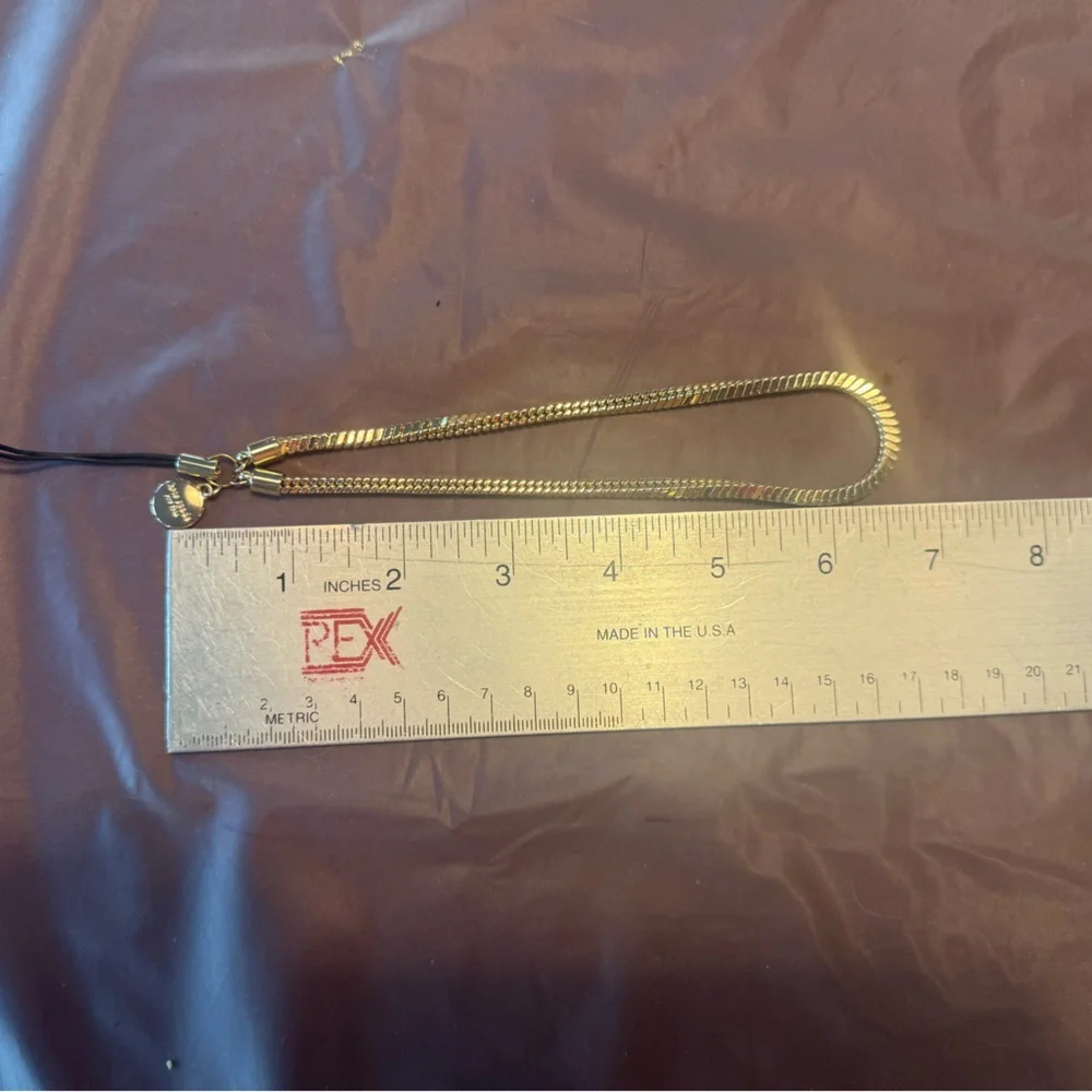 kate spade Gold Tone Phone Wrist Strap with Black Cord Loop
